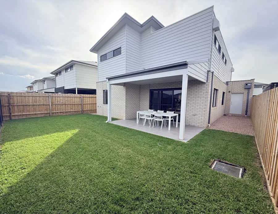 Backyard with new turf, timber fencing and alfresco area